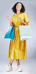 Image showing Portrait, shopping bag and a woman in studio for fashion sale, promotion or retail discount. African female model or happy customer on a white background for advertising commerce offer, deal or gift