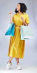 Image showing Thinking, smile and woman with shopping bag for fashion in studio isolated on a white background. Happy, sales and African customer with gift, discount deal or clothes from shop, mall or retail store