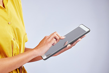 Image showing Hands, tablet and closeup of a woman in studio scrolling on social media, mobile app or the internet. Online, research and female person browsing on website with digital technology by gray background