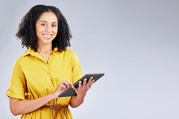 Image showing Smile, email and portrait of a woman with a tablet on a studio background for communication. Happy, work and a young girl or employee typing on technology with mockup space for an app or internet