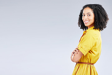 Image showing Portrait, fashion and mockup with a woman arms crossed in studio on a white background for trendy style. Yellow, smile and banner with a happy young person with an afro in a clothes outfit on space