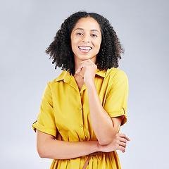 Image showing Portrait, fashion and smile with a model woman in studio on a gray background for trendy style. Yellow, beauty and a happy or confident young female person with an afro posing in a clothes outfit