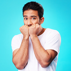 Image showing Fear, scared and portrait of man nervous, anxiety or anxious due to crisis or stress isolated in a studio blue background. Worry, suspense and young male person hands in face for mistake reaction