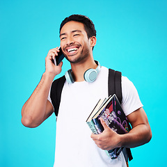 Image showing Talking, phone and college student in studio with backpack for university, education and studying books on blue background. Happy, man and person excited for learning and mobile network connection