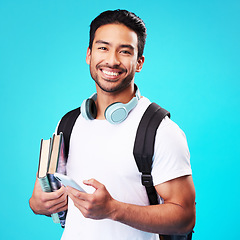 Image showing Indian, college student and portrait with phone in studio and backpack for university, education and connection on blue background. Happy, man and person excited to study and learn for future goals