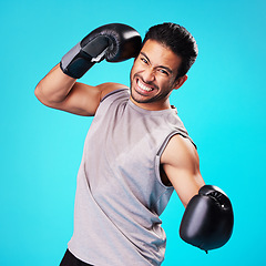 Image showing Boxer man, punch and studio portrait with sweat, workout and training for fitness by blue background. Guy, boxing gloves and power for exercise, fight and development for performance in combat sports