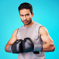 Image showing Portrait, man and fighter training, boxing or challenge on a blue studio background. Male person, Asian boxer or athlete with power, strong or serious face with workout, fight or wellness with sports