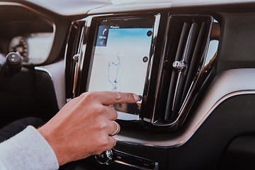 Image showing Close-up Of Man Hand Using GPS Navigation Inside Car