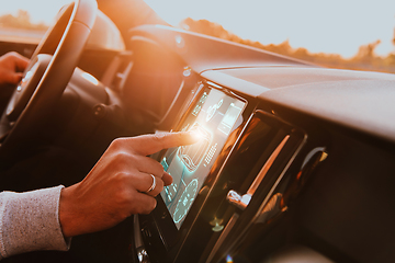 Image showing Close-up of a man's finger adjusting autopilot on the touch screen