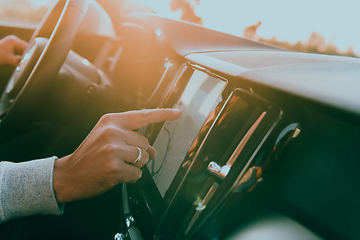 Image showing Close-up Of Man Hand Using GPS Navigation Inside Car