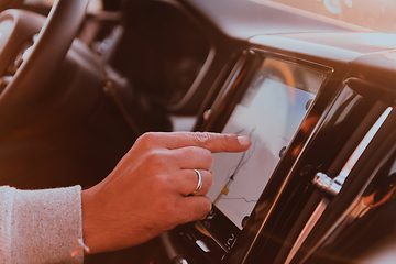 Image showing Close-up Of Man Hand Using GPS Navigation Inside Car