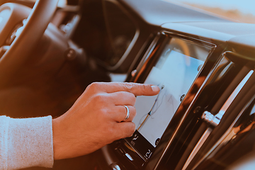 Image showing Close-up Of Man Hand Using GPS Navigation Inside Car