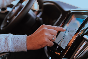 Image showing Close-up Of Man Hand Using GPS Navigation Inside Car