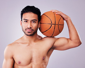 Image showing Portrait, basketball and body with a sports man in studio on a gray background for training or a game. Fitness, muscle or mindset and a shirtless young male athlete holding a ball with focus