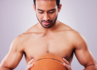 Image showing Exercise, basketball and a shirtless sports man in studio on a gray background for training or a game. Fitness, workout or mindset and a young male athlete holding a ball with focus or confidence