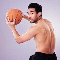 Image showing Sports, exercise and basketball with a man playing in studio on a gray background for training or a game. Healthy, body or shirtless and a young male athlete holding a ball for fitness competition