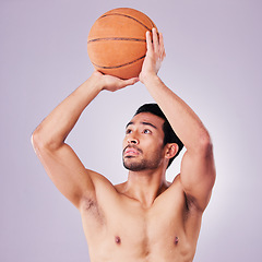 Image showing Fitness, basketball and a sports asian man shooting in studio on a gray background for training or a game. Exercise, body or aim and a shirtless young male athlete holding a ball during a competition