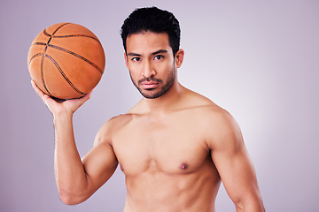 Image showing Portrait, basketball and focus with a sports man in studio on a gray background for training or a game. Fitness, body or shirtless and a young male athlete holding a ball with focus or confidence