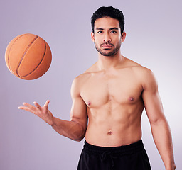 Image showing Portrait, sports and basketball with a man in studio on a gray background for training or a game. Exercise, workout or mindset and a confident young male athlete with a ball for a competitive hobby