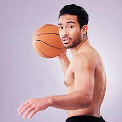 Image showing Portrait, playing basketball and a sports man in studio on a gray background for training or a game. Exercise, workout or mindset and a young male athlete holding a ball to play a competitive match