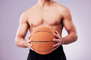 Image showing Hands, basketball and a shirtless sports man in studio on a gray background for training or a game. Exercise, workout or body and a male athlete holding a ball while posing topless for fitness