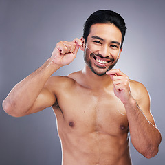 Image showing Flossing teeth, studio portrait or happy man with oral health hygiene, wellness grooming or tooth treatment string. Morning bathroom routine, aesthetic smile or dental care person on gray background