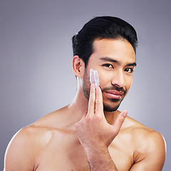 Image showing Skincare portrait, cream and studio man with facial cleaning routine, morning hydration or spa self care. Bathroom cosmetics, face lotion product and aesthetic person wellness on gray background