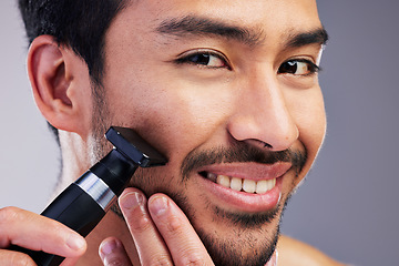 Image showing Beard hair trimmer, happiness and man portrait for bathroom shaving, blade grooming or morning beauty routine. Studio razor, facial cleaning and closeup person with fresh face glow on gray background