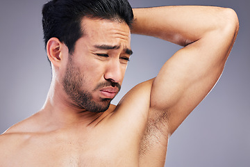 Image showing Armpit, smell and man with body odor in studio isolated on a white background for deodorant, cleaning and skincare cosmetic. Underarm, bad stink and model with hyperhidrosis, sweating or poor hygiene