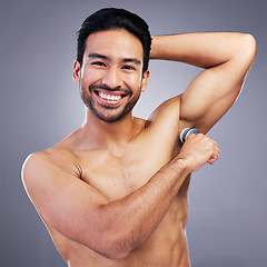 Image showing Portrait, man and deodorant on clean armpit for hygiene, routine and control of sweat with beauty product on studio background. Antiperspirant, skin or smell, scent and skincare perfume or cosmetics