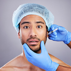 Image showing Hands, portrait and plastic surgery with a man in studio on a gray background for a botox injection. Face, beauty and transformation with a male customer in a clinic for antiaging filler or cosmetics