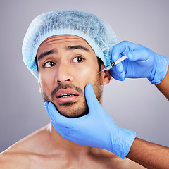 Image showing Scared, man or plastic surgery injection for facelift or cosmetics isolated in studio on white background. Hands, fear or worried Asian male person with needle for skin beauty in medical procedure