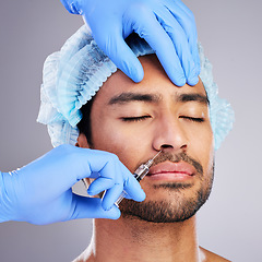 Image showing Hands, facelift and plastic surgery with a man in studio on a gray background for a botox injection. Face, change and transformation with a male customer in a clinic for beauty or antiaging filler