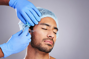 Image showing Hands, aesthetic and plastic surgery with a man in studio on a gray background for silicon injection. Facial, beauty or transformation with a male customer in a clinic for antiaging filler or implant