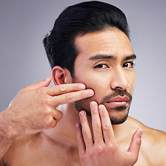 Image showing Portrait, studio or man check skin blackhead, melasma or pimple breakout during facial cleaning, grooming or morning routine. Anxiety, face acne or spa person with skincare problem on gray background