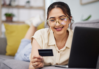 Image showing Woman, credit card and finance with laptop on sofa for digital payment, fintech password and online shopping. Happy female customer, computer and banking code for financial sales investment at home