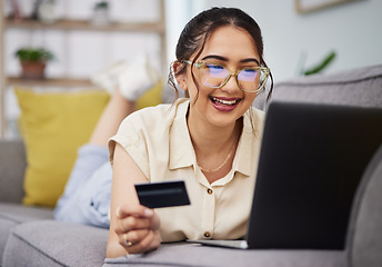 Image showing Happy woman, credit card and money with laptop on sofa for ecommerce payment, fintech password and online shopping. Female customer, computer and banking code for financial sales promotion at home