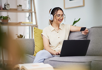 Image showing Woman, credit card and laptop with headphones in home for digital payment, fintech password and online shopping. Happy female customer, computer account and banking code to upgrade music subscription