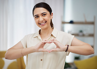 Image showing Portrait, heart and hands of woman in home for care, charity and kindness on valentines day. Happy female person with finger shape for love icon, thank you and emoji in support of freedom in lounge