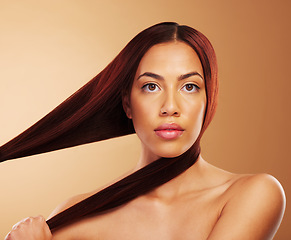 Image showing Aesthetic, beauty and portrait of woman with strong hair in hands, luxury salon treatment and brown background. Natural glow, haircut and haircare, face of model with cosmetics and makeup in studio.