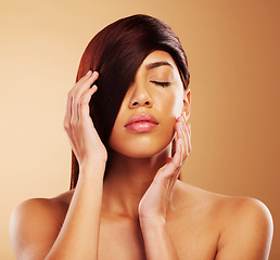 Image showing Hair care, beauty and a woman in studio for salon, hairdresser and wellness results. Self care, cosmetics and shampoo for growth and shine of an aesthetic model person on a brown background