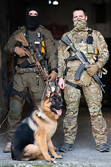 Image showing Modern Warfare Soldiers with military working dog in action on the battlefield.