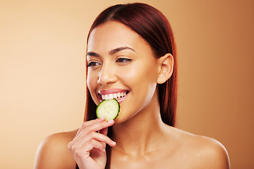 Image showing Thinking, cucumber and woman with skincare, dermatology and cosmetics on a brown studio background. Female person, healthy fruit and model with wellness, glow and beauty with shine, natural and ideas