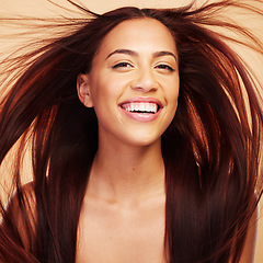 Image showing Wind, beauty or portrait of happy woman with hair care after salon treatment isolated on brown background. Natural glow, breeze and face of proud model with cosmetics, smile or hairstyle in studio