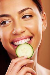 Image showing Thinking, cucumber and woman with skincare, natural beauty and cosmetics on a brown studio background. Female person, healthy fruit and model with wellness, glow and dermatology with shine and ideas