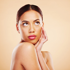 Image showing Face touch, beauty skincare and woman in studio isolated on a brown background mockup space. Cosmetic, natural and model thinking of spa facial treatment for dermatology, aesthetic and skin wellness