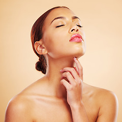 Image showing Beauty, skincare touch and woman with eyes closed in studio isolated on brown background. Face, makeup cosmetics and natural model touch neck after spa facial treatment for wellness and healthy skin