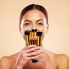 Image showing Makeup, brush and portrait of woman with cosmetic beauty product for skincare isolated in a studio brown background. Happy, elegant and powder for cosmetology aesthetic, glow and soft skin glamour