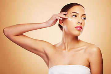 Image showing Skincare, beauty and a woman with cream on a studio background for wellness and moisture. Cosmetics, product and a young girl or model with lotion or sunscreen for facial skin health on a backdrop