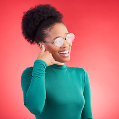 Image showing Call me, woman and portrait in studio with model and phone hand gesture for talk. Red background, happy female person and flirting with speaking, mobile and contact icon and sign with a smile